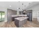 Beautiful kitchen featuring gray cabinets, stainless steel appliances, marble countertops, and an island at 14085 Sw 34Th Terrace Rd, Ocala, FL 34473