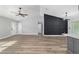 Bright living room featuring durable wood-look flooring, black accent wall, modern fixtures and entry to bedrooms at 14085 Sw 34Th Terrace Rd, Ocala, FL 34473