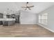 Living room flows into island kitchen with stainless steel appliances, durable flooring, and open-concept design at 14085 Sw 34Th Terrace Rd, Ocala, FL 34473