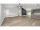 Bright living room featuring durable wood-look flooring, open concept to island kitchen, and modern finishes at 14085 Sw 34Th Terrace Rd, Ocala, FL 34473