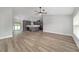 Spacious living room with a ceiling fan that opens to the kitchen with stainless appliances at 14085 Sw 34Th Terrace Rd, Ocala, FL 34473