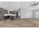 Living room open to kitchen with modern cabinets, fixtures, stainless appliances, and durable wood-look flooring at 14085 Sw 34Th Terrace Rd, Ocala, FL 34473