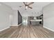 Open-concept living room featuring durable wood-look flooring, modern fixtures, and island kitchen at 14085 Sw 34Th Terrace Rd, Ocala, FL 34473