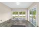 Sunroom featuring tile flooring, large sliding glass doors providing backyard view and lots of natural light at 14085 Sw 34Th Terrace Rd, Ocala, FL 34473
