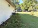 Side yard featuring lush green grass and mature landscaping at 19059 Sw 92Nd Loop, Dunnellon, FL 34432