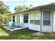Charming backyard patio with outdoor seating and a well-manicured lawn at 19059 Sw 92Nd Loop, Dunnellon, FL 34432