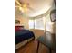 Bedroom featuring natural light, ceiling fan, desk, and hard flooring at 19059 Sw 92Nd Loop, Dunnellon, FL 34432