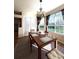 Bright dining room with a wooden table, decorative chandelier, and large windows offering outdoor views at 19059 Sw 92Nd Loop, Dunnellon, FL 34432