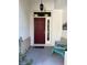 Inviting front door with decorative accents, complemented by a cozy seating area at 19059 Sw 92Nd Loop, Dunnellon, FL 34432