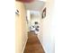 Hallway leads to a cozy living room with an L-shaped sectional couch at 19059 Sw 92Nd Loop, Dunnellon, FL 34432