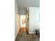 Hallway with hard floors that leads to a bathroom with a shower at 19059 Sw 92Nd Loop, Dunnellon, FL 34432