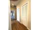 Hallway with hard surface floors and white doors with access to rooms in the house at 19059 Sw 92Nd Loop, Dunnellon, FL 34432