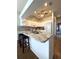 This bright kitchen features white cabinets, granite countertops and a stylish breakfast bar with seating at 19059 Sw 92Nd Loop, Dunnellon, FL 34432