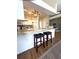 Modern kitchen featuring white cabinetry, granite countertops, and stylish seating at the breakfast bar at 19059 Sw 92Nd Loop, Dunnellon, FL 34432