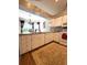 Bright kitchen with white cabinetry and appliances overlooks dining area at 19059 Sw 92Nd Loop, Dunnellon, FL 34432