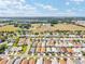 An aerial perspective capturing a well-planned residential area with green landscaping set against a partly cloudy sky at 2693 Craven Way, The Villages, FL 32162