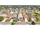 Aerial view of a residential neighborhood featuring a well-maintained community with uniform homes and manicured lawns at 2693 Craven Way, The Villages, FL 32162
