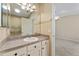 Bathroom featuring single vanity, large mirror, and walk-in shower at 2693 Craven Way, The Villages, FL 32162