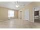 Spacious bedroom with ceiling fan, tile floors, and view of multiple doorways at 2693 Craven Way, The Villages, FL 32162