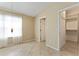 Comfortable bedroom with tile flooring, natural light, and access to the closet for easy organization at 2693 Craven Way, The Villages, FL 32162