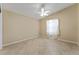 Bright bedroom with neutral walls, tiled floors, and a ceiling fan for a comfortable and serene atmosphere at 2693 Craven Way, The Villages, FL 32162