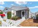 Charming home featuring a landscaped yard, an American flag, and a cozy screened-in porch at 2693 Craven Way, The Villages, FL 32162