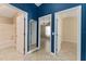 Hallway with blue walls leading to the bathroom and bedrooms at 2693 Craven Way, The Villages, FL 32162