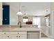 Kitchen with stainless steel dishwasher, a breakfast bar and view to the living space at 2693 Craven Way, The Villages, FL 32162