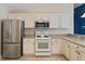 Kitchen featuring modern stainless steel appliances and tiled floor at 2693 Craven Way, The Villages, FL 32162