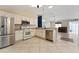 Bright kitchen boasts stainless steel appliances, neutral countertops, and ample cabinet space at 2693 Craven Way, The Villages, FL 32162