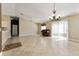 Bright living room with tile floors, a piano, and sliding doors to the outdoor space at 2693 Craven Way, The Villages, FL 32162