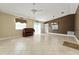 Spacious living room with tile flooring, piano, and abundant natural light at 2693 Craven Way, The Villages, FL 32162