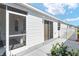 Home exterior featuring sliding glass door leading to a tiled patio at 2693 Craven Way, The Villages, FL 32162