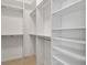 Spacious walk-in closet features custom shelving and ample storage space for an organized wardrobe at 2693 Craven Way, The Villages, FL 32162