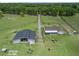 Aerial view of property showcasing the house, barn and surrounding acreage at 2780 Ne 127Th Pl, Anthony, FL 32617