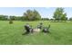 Relaxing backyard features Adirondack chairs around a stone fire pit at 2780 Ne 127Th Pl, Anthony, FL 32617