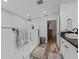 Bright primary bathroom features a sleek walk-in shower, modern fixtures, and wood floors at 2780 Ne 127Th Pl, Anthony, FL 32617