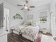 Bedroom with two beds, a ceiling fan, and an attached bathroom at 2780 Ne 127Th Pl, Anthony, FL 32617