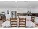 Sunlit dining area with wood floors adjoins a modern kitchen with stainless steel appliances at 2780 Ne 127Th Pl, Anthony, FL 32617