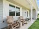 Charming front porch with rocking chairs and a view of the landscaped yard at 2780 Ne 127Th Pl, Anthony, FL 32617