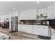 Modern kitchen features sleek white cabinets, wood countertops, and stainless steel appliances at 2780 Ne 127Th Pl, Anthony, FL 32617