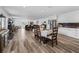 Open-concept living and dining area features wood floors, modern lighting, and backyard access at 2780 Ne 127Th Pl, Anthony, FL 32617