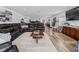 Expansive living room showcasing a large sectional sofa, area rug, and views of the kitchen at 2780 Ne 127Th Pl, Anthony, FL 32617