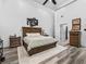 Bright main bedroom featuring vaulted ceiling, wood floors, and en-suite bathroom access at 2780 Ne 127Th Pl, Anthony, FL 32617