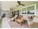 Inviting outdoor patio featuring comfortable seating, stylish decor, and scenic views of the property at 2780 Ne 127Th Pl, Anthony, FL 32617