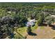 Aerial view of the property showcases a sprawling landscape with lush greenery and private pool at 3230 Se 45Th St, Ocala, FL 34480