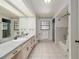 Bathroom featuring double sinks, a long vanity, and separate shower and tub at 3230 Se 45Th St, Ocala, FL 34480