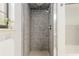 Tiled walk-in shower area featuring glass enclosure and neutral tones at 3230 Se 45Th St, Ocala, FL 34480