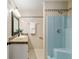 Bathroom featuring decorative tile accents, granite countertop, and an enclosed shower with updated hardware at 3230 Se 45Th St, Ocala, FL 34480