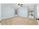 Inviting bedroom features soft blue walls, neutral carpet, and dual windows providing ample natural light at 3230 Se 45Th St, Ocala, FL 34480